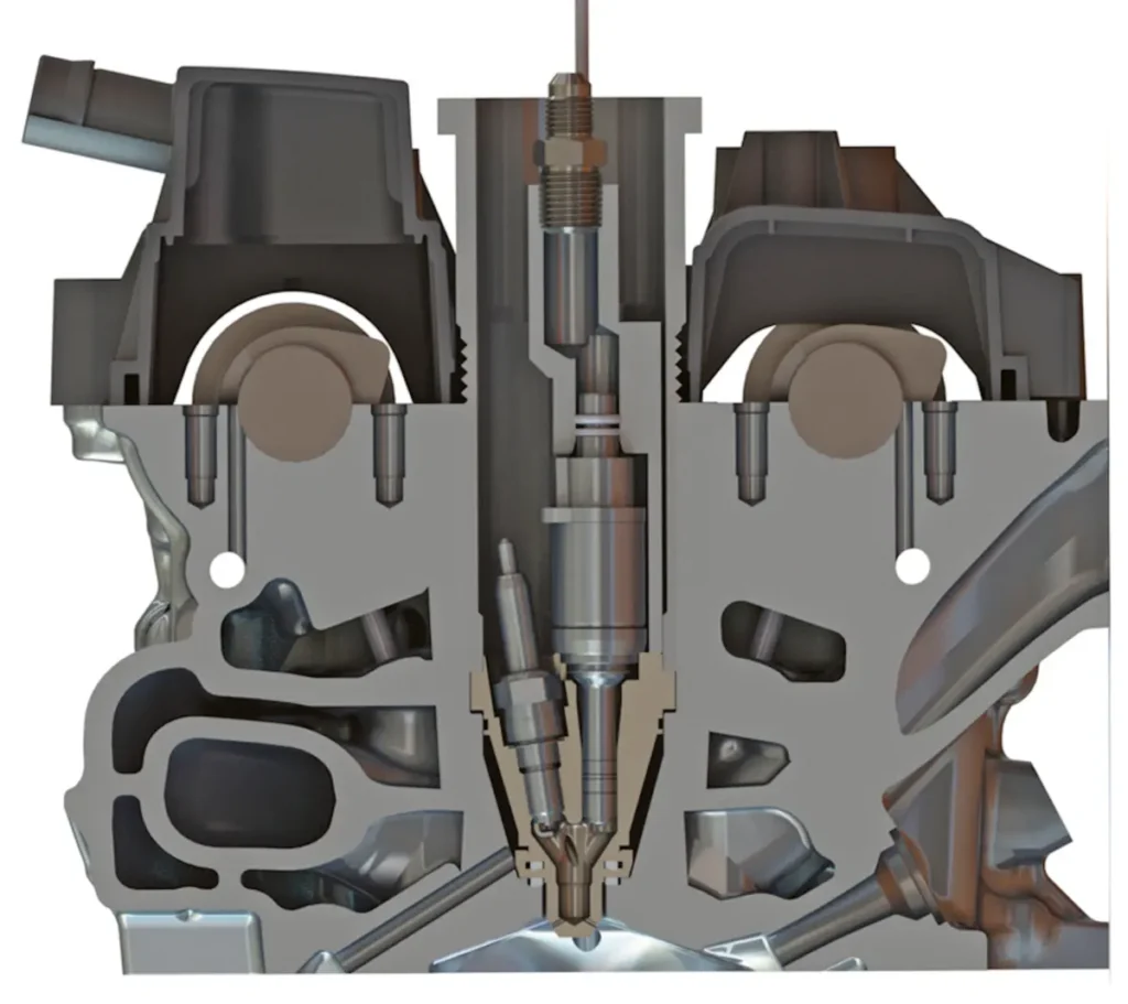 A Mahle féle Jet Ignition rendszer metszete a hengerfejben. Jól látható a befecskendező, maga a kamra és a gyertya is